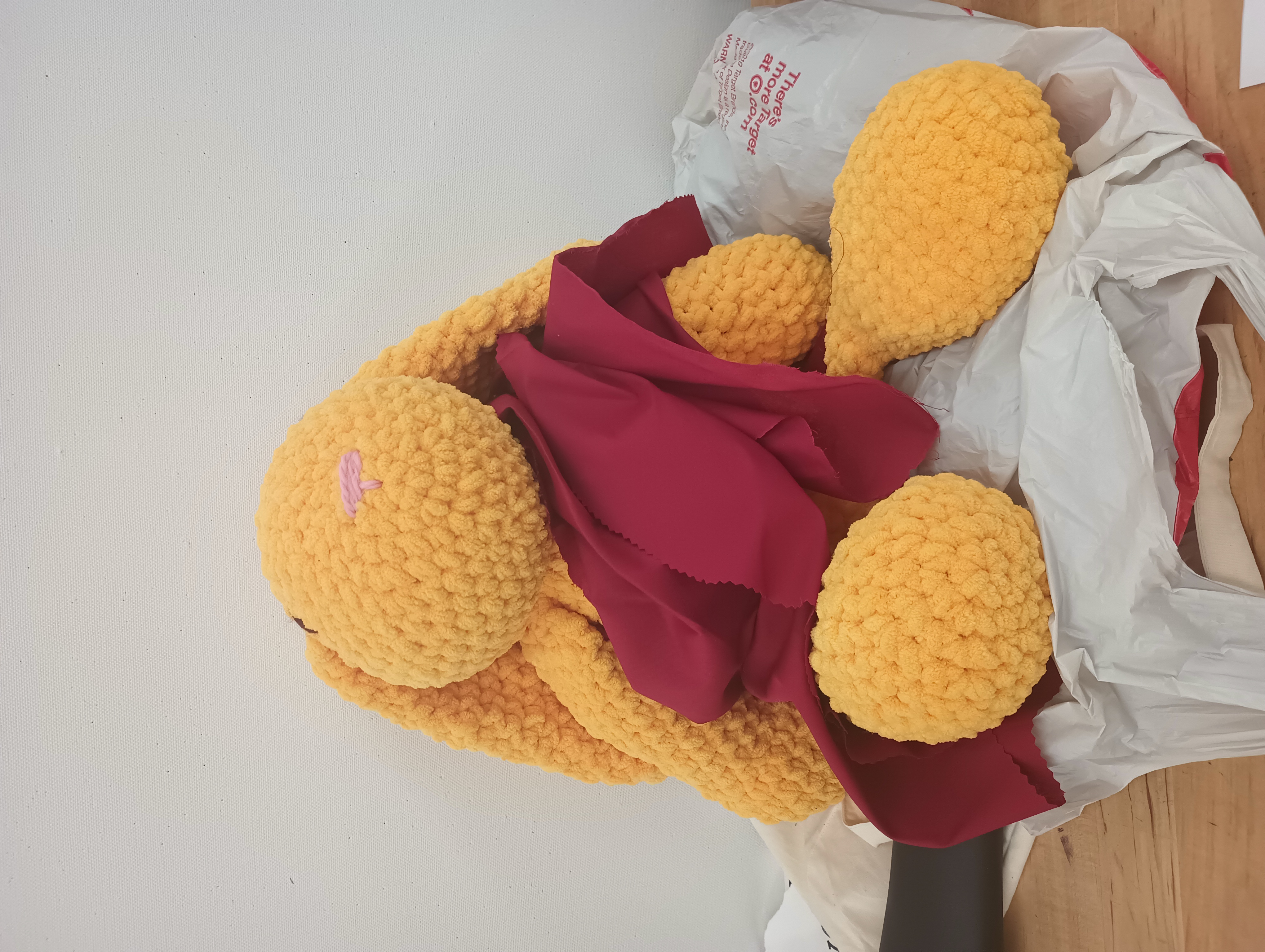 A large stuffed rabbit wearing a red toga.