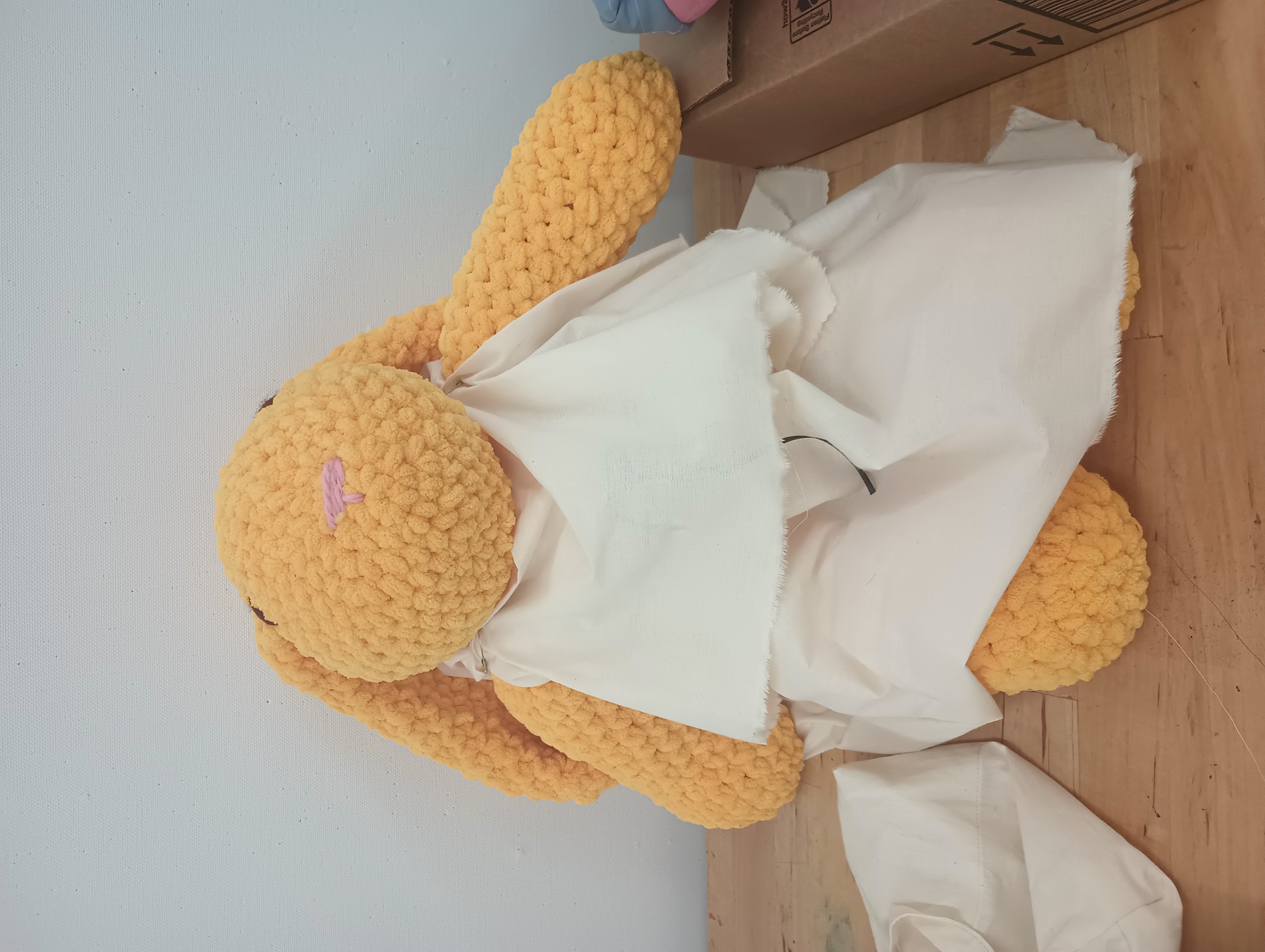 A large stuffed rabbit wearing a white peplos.